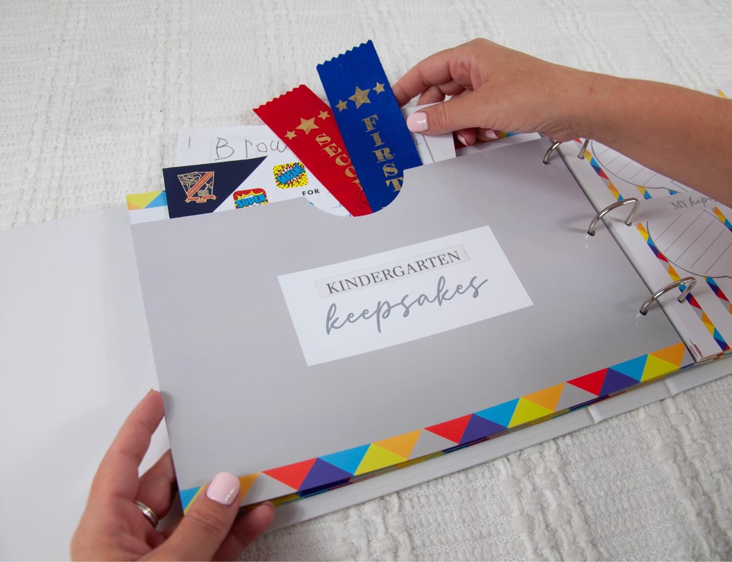 placing keepsakes in kindergarten pocket of school memory book